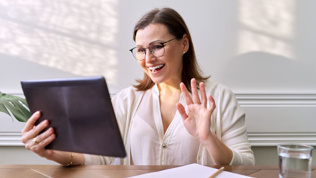 Psychologist Looking at Webcam of Digital Tablet